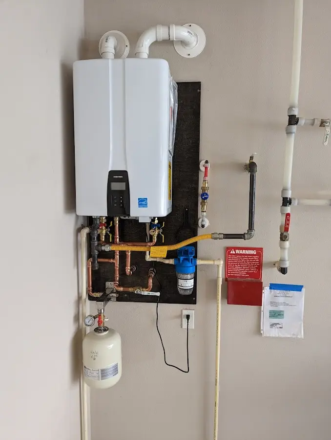 Professional plumber installing copper piping in a Shelby home